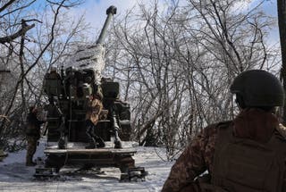 Ukrainian troops fire towards Russian troops near a front line in Kharkiv region, 9 February